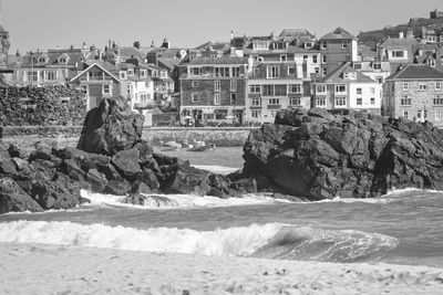 Scenic view of sea by buildings in city