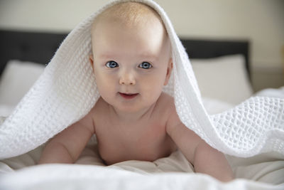 Portrait of cute baby on bed