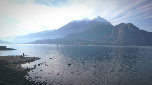 Scenic view of lake and mountains against sky