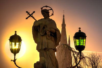 Low angle view of illuminated statue against sky during sunset