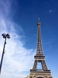 Eiffel tower by day. bright blue sky and whispy white clouds  low angle view. paris, france. 