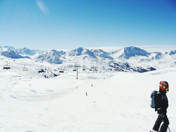 People skiing on snow covered landscape