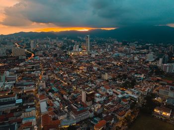 High angle view of city buildings against sky during sunset