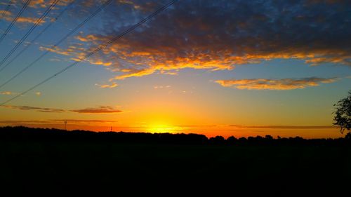 Scenic view of silhouette landscape against sky at sunset