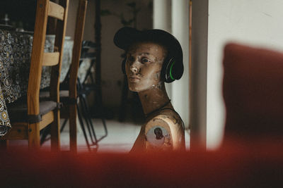 Portrait of young woman sitting at home