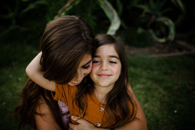 Mother & daughter embracing in san diego