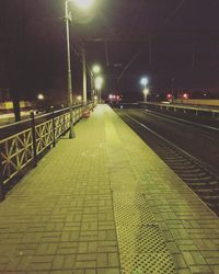 Illuminated railroad track at night