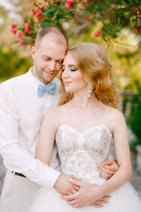 Couple embracing during wedding ceremony outdoor