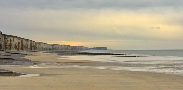 Scenic view of beach against sky during sunset