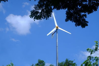 Low angle view of windmill against sky