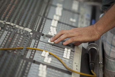 Close-up of hand using sound mixer