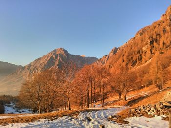 Scenic view of mountains against clear blue sky