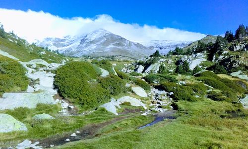 Scenic view of river and mountains against sky