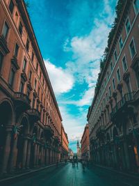 Street amidst buildings in town against sky