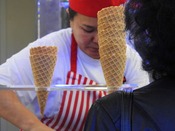 Midsection of man holding ice cream