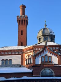 Low angle view of historic building against clear blue sky