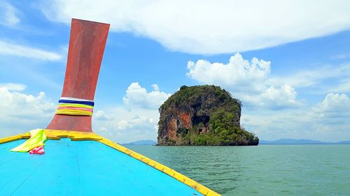 Rock formations in sea against sky