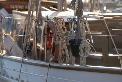 Part of a ship showing deck and different ropes and lines.