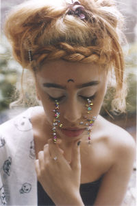 Optical illusion of woman crying with colorful tears