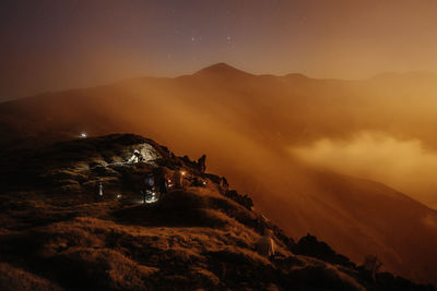 Scenic view of mountains against sky at night