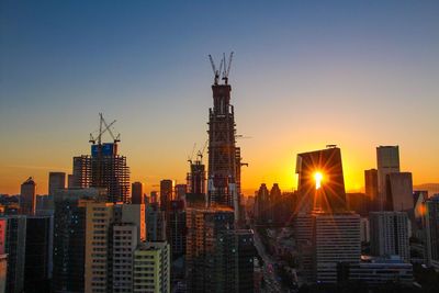 Cityscape against sky during sunset