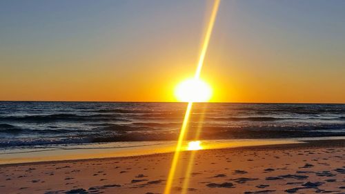 Scenic view of sea against clear sky during sunset