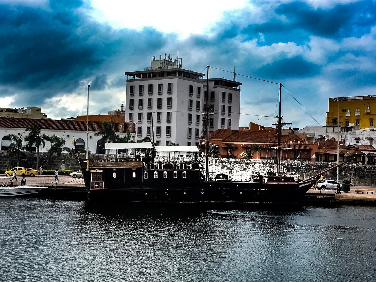 architecture, building exterior, built structure, cloud - sky, sky, nautical vessel, transportation, water, waterfront, day, mode of transport, travel destinations, outdoors, city, moored, large group of people, real people, people