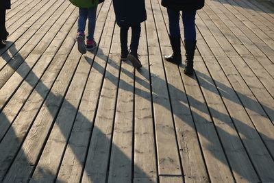 Low section of people walking on zebra crossing