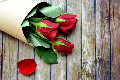 Close-up of red rose on table