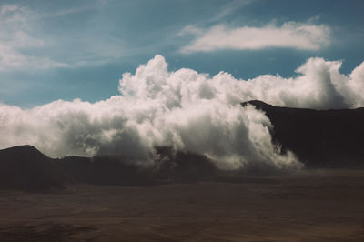 Scenic view of clouds over landscape against sky