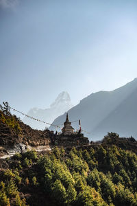 Panoramic view of trees and buildings against sky