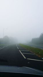 Road passing through foggy weather