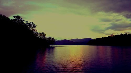 Scenic view of silhouette mountains against sky at sunset