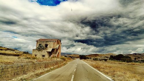 View of old building against cloudy sky