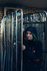 Woman wearing hooded jacket looking away