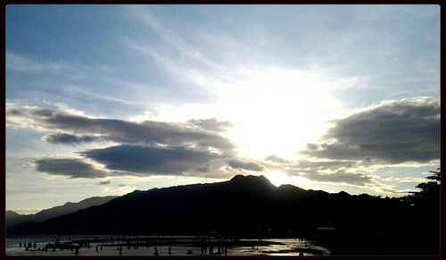 Scenic view of mountains against cloudy sky
