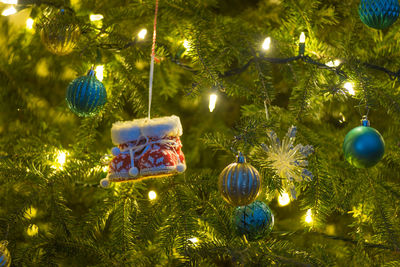 Close-up of christmas decorations hanging on tree