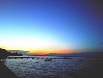 Scenic view of sea against clear sky during sunset