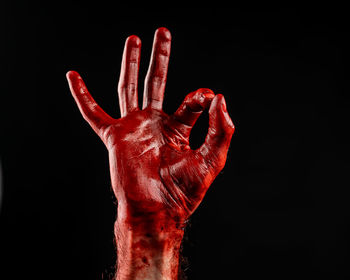 Close-up of human hand against black background