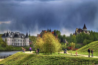 Panoramic view of buildings against cloudy sky