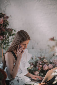 Woman sitting on mobile phone