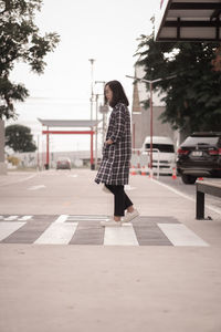 Portrait of young woman walking on street