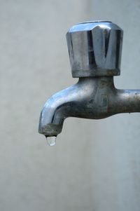 Close-up of drop dripping from faucet