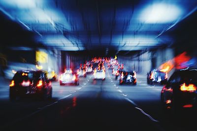 Vehicles on road in city at night