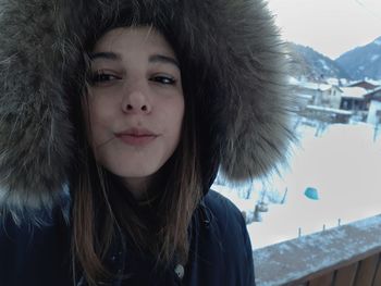 Close-up portrait of young woman in snow