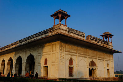 Low angle view of historical building against blue sky