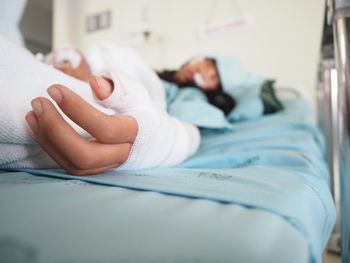 Midsection of baby sleeping in bed