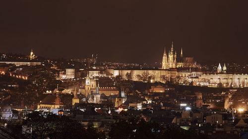 Illuminated cityscape against sky at night