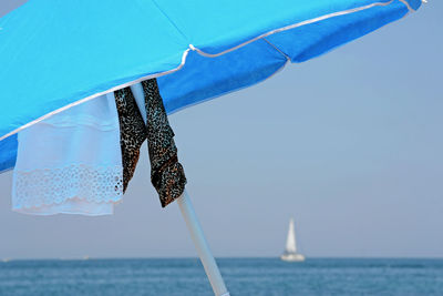 Sailboat in sea against clear sky