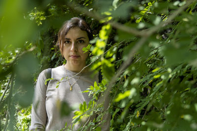 Young woman descending in the ravine, vegetation and trees, huentitan ravine guadalajara, mexico